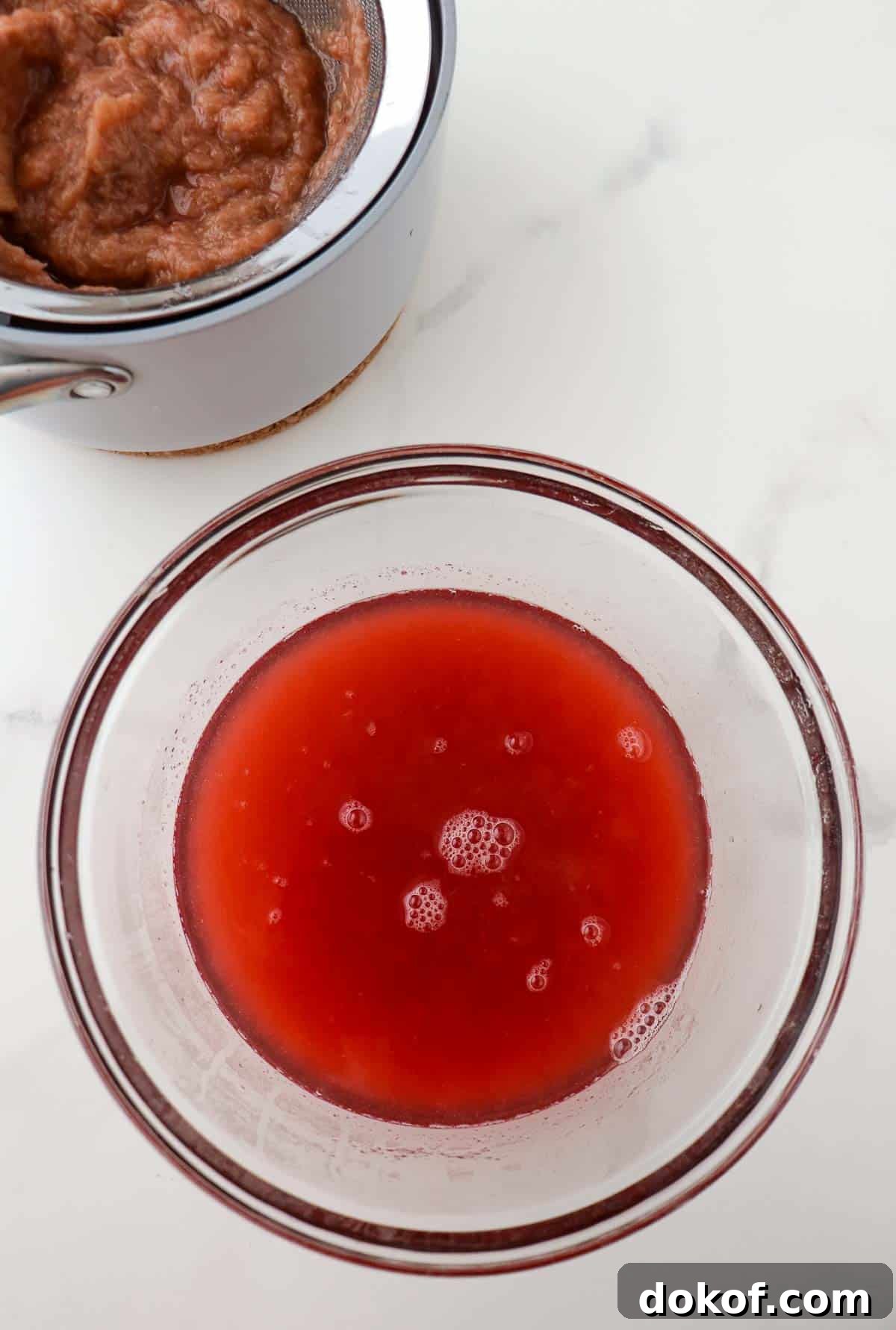 Rhubarb syrup in a glass bowl.