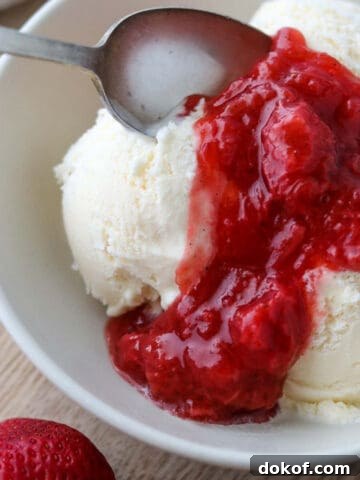 Close up of Strawberry Rhubarb Compote on ice cream.