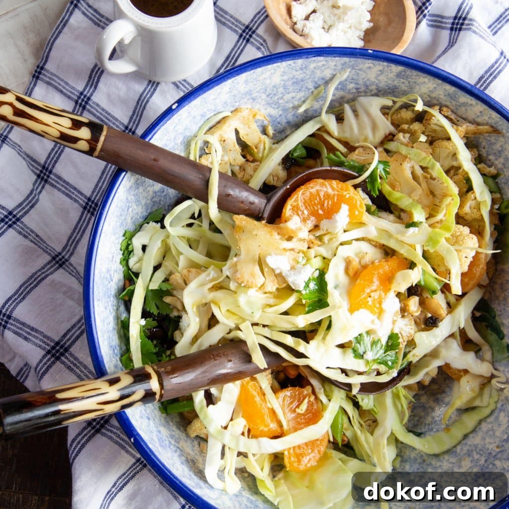 Winter citrus salad tossed with roasted cauliflower, cashews, feta, and shredded cabbage.