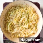 A braiser of freshly cooked French Braised Cabbage on top of an induction stovetop.