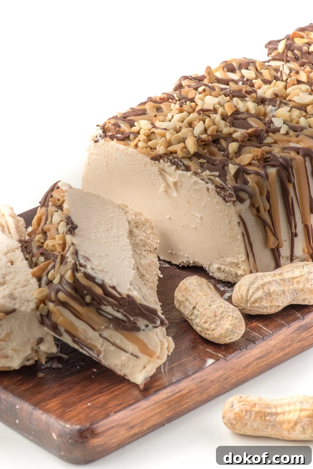 a loaf shaped peanut butter ice cream cake sliced on a cutting board