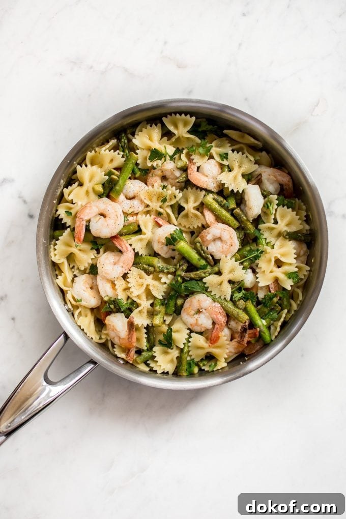 easy shrimp asparagus pasta in a metal skillet