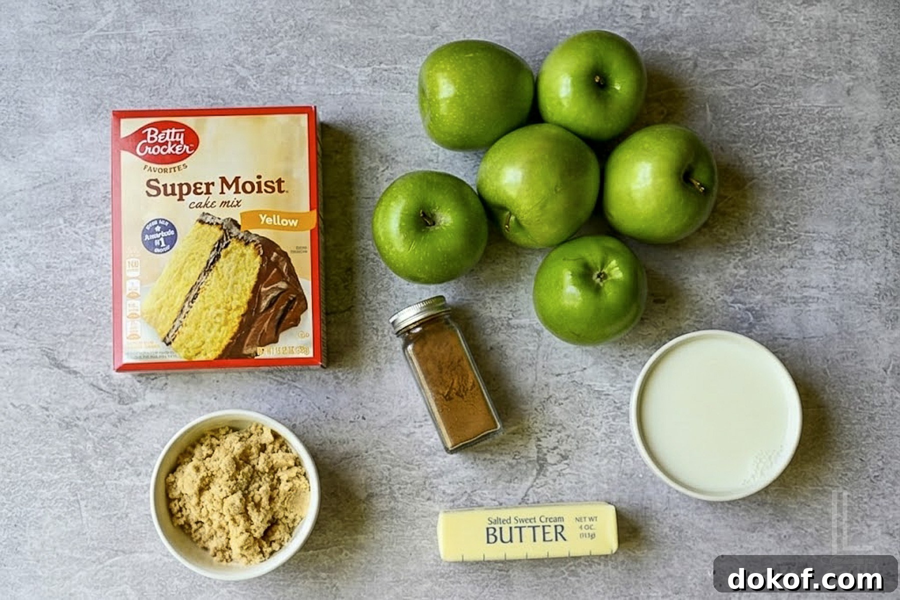 ingredients for easy apple cobbler (cake mix, apples, brown sugar, cinnamon, butter, and milk).