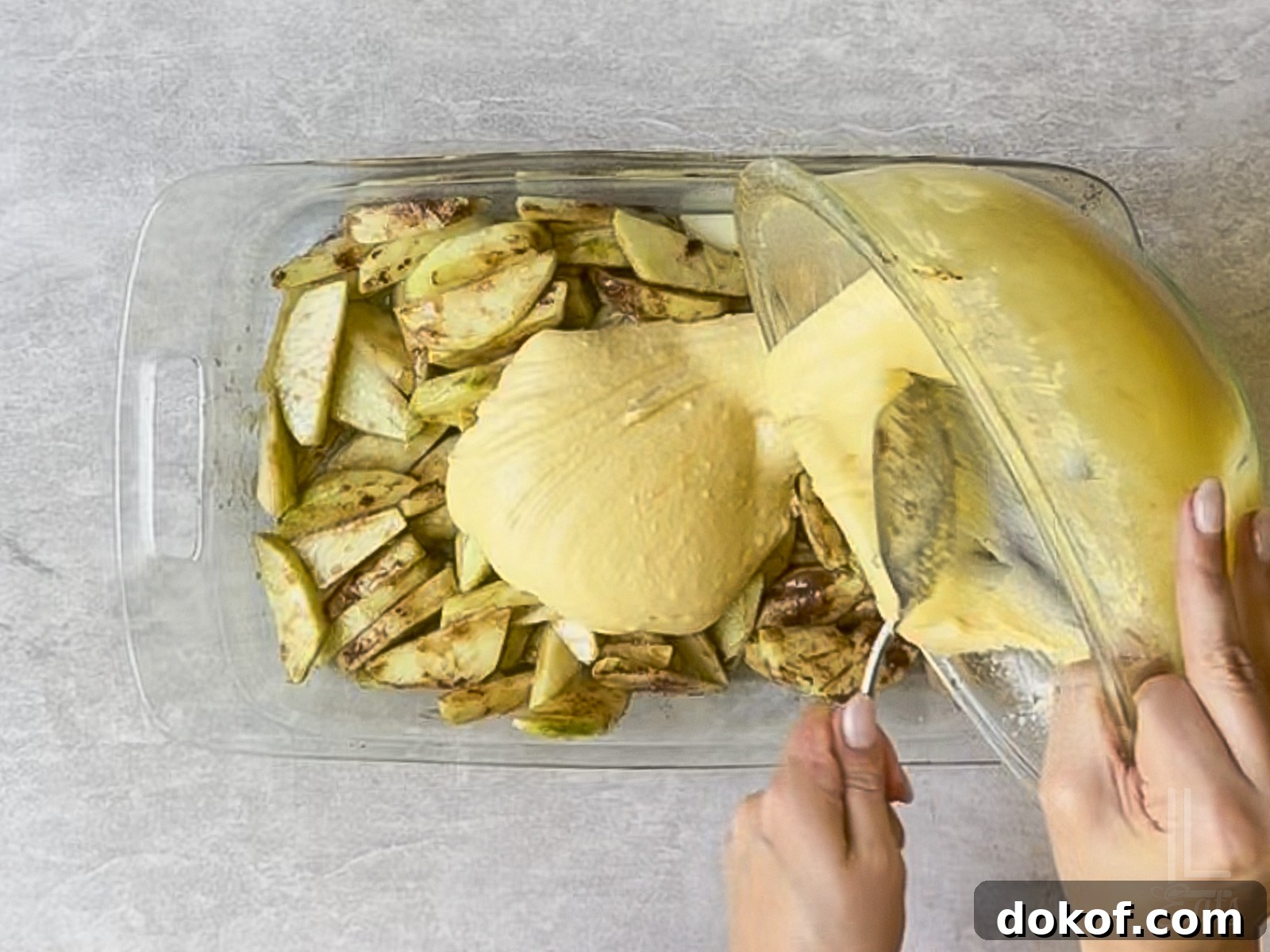 covering the apples with cake mix batter.
