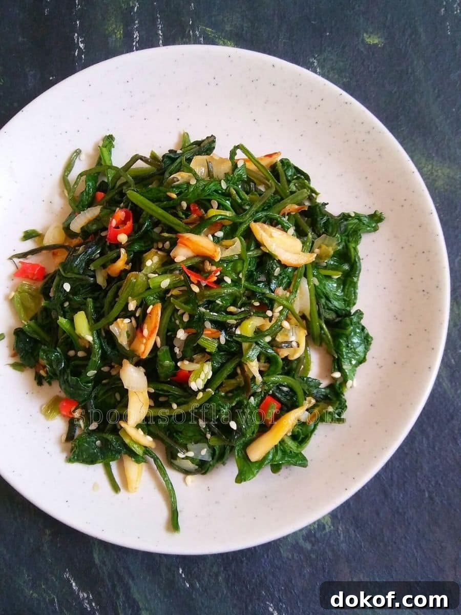 Stir fried spinach served on a white plate