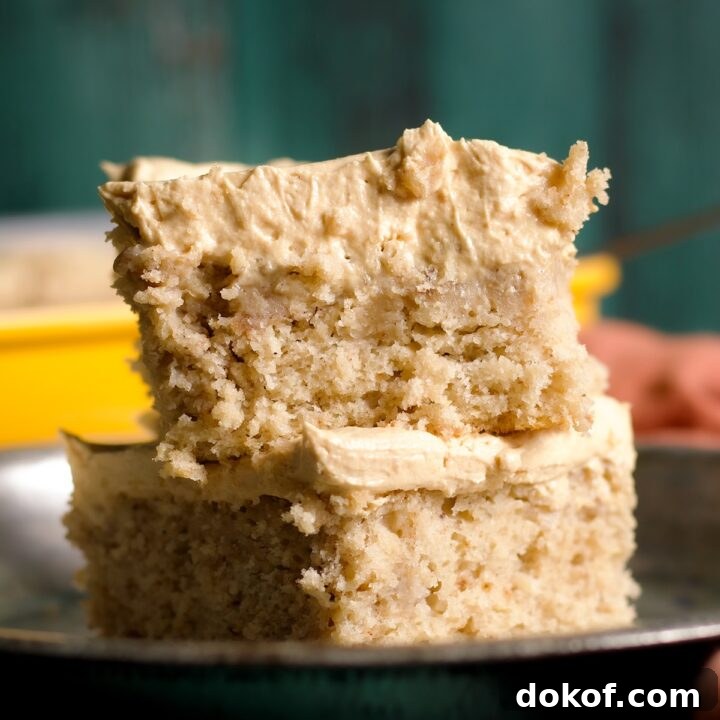 Two slices of banana snack cake covered in peanut butter frosting.