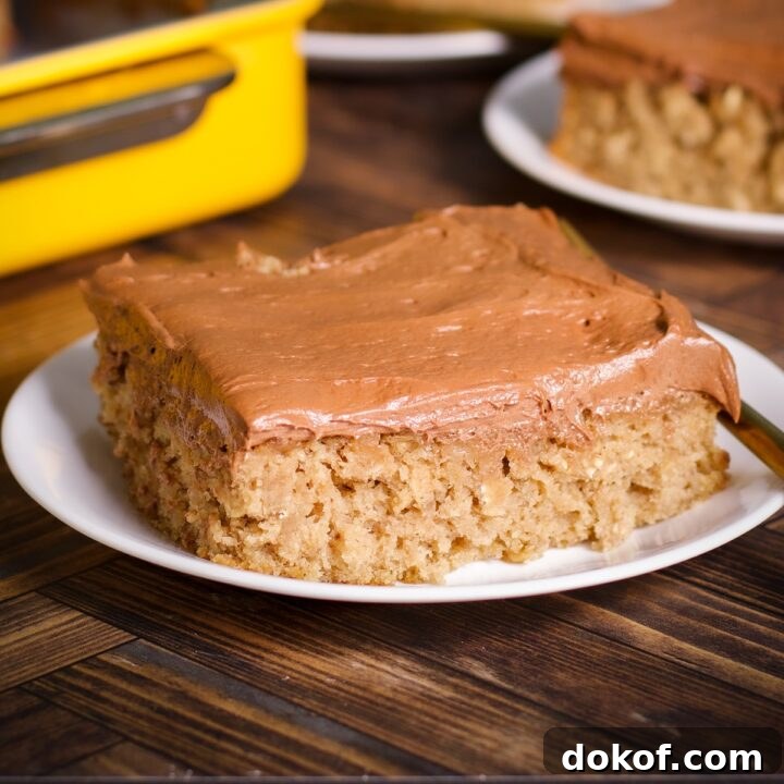 A slice of banana oat cake with chocolate buttercream on a plate.
