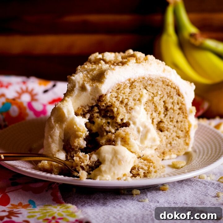 A slice of banana cream cake on a white plate.
