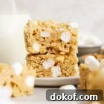 gluten-free peanut butter rice krispie treats stacked on a white plate