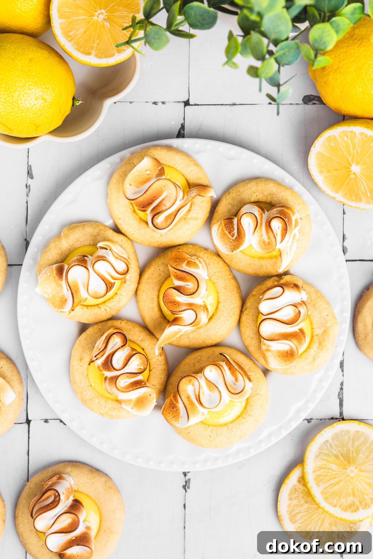 lemon meringue cookies with lemon curd and toasted meringue on a plate