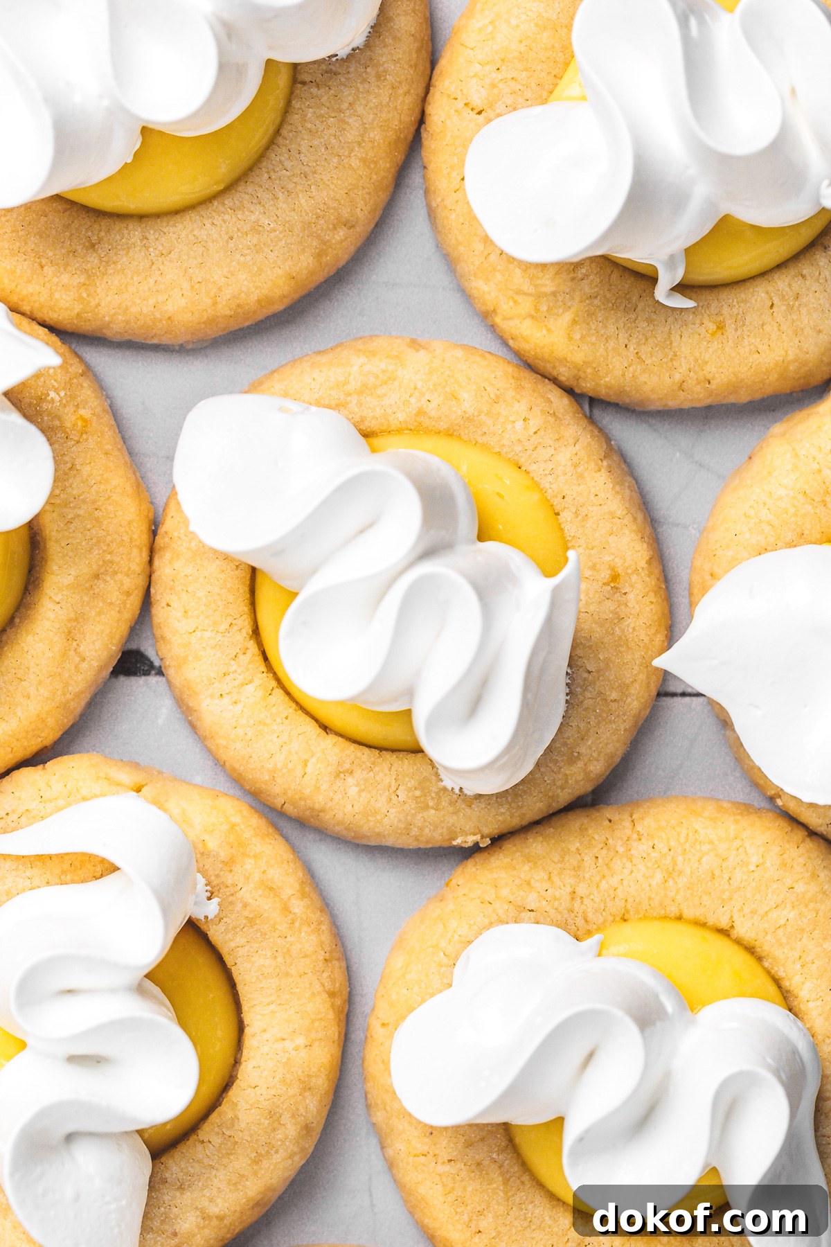 piping toasted meringue on lemon curd cookies