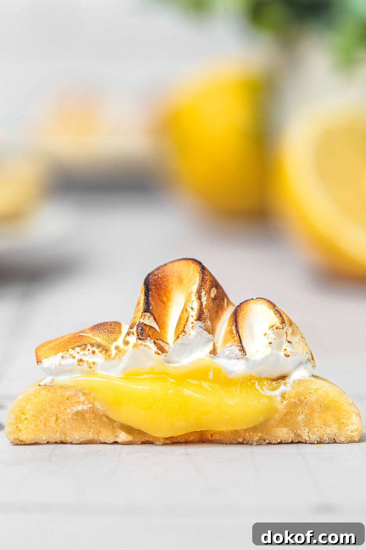 close-up of lemon meringue cookies with lemon filling and meringue on a serving plate