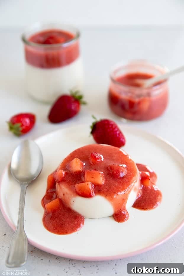 side view of a serving of coconut milk panna cotta topped with strawberry sauce