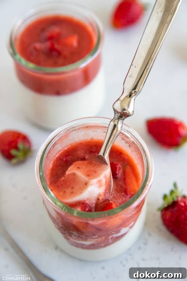 a spoon dipping into a small jar with homemade dairy-free coconut panna cotta