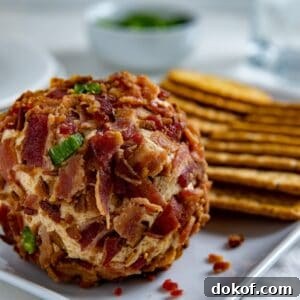 Jalapeno Cheese ball and Crackers on white rectangular serving dish.