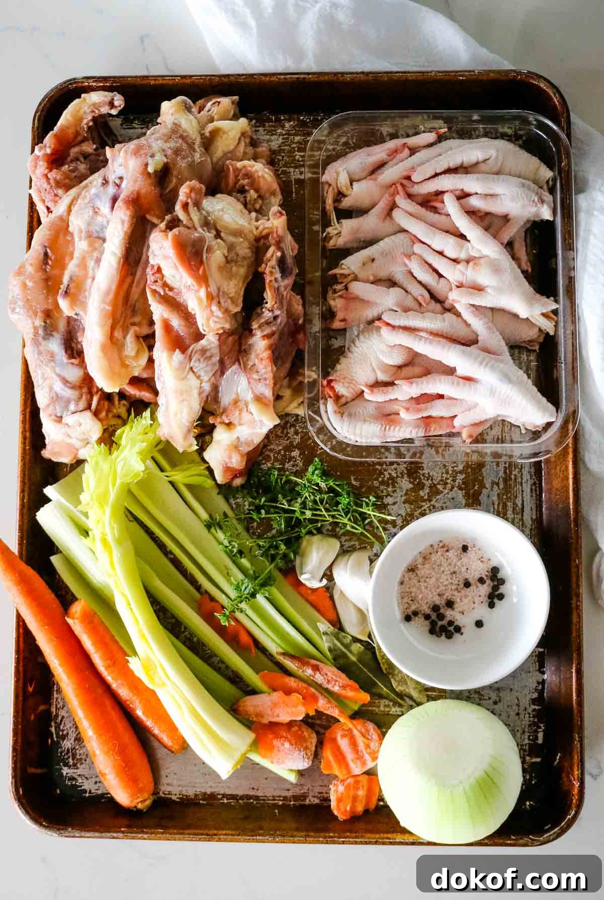 Chicken broth ingredients on a roasting sheet.