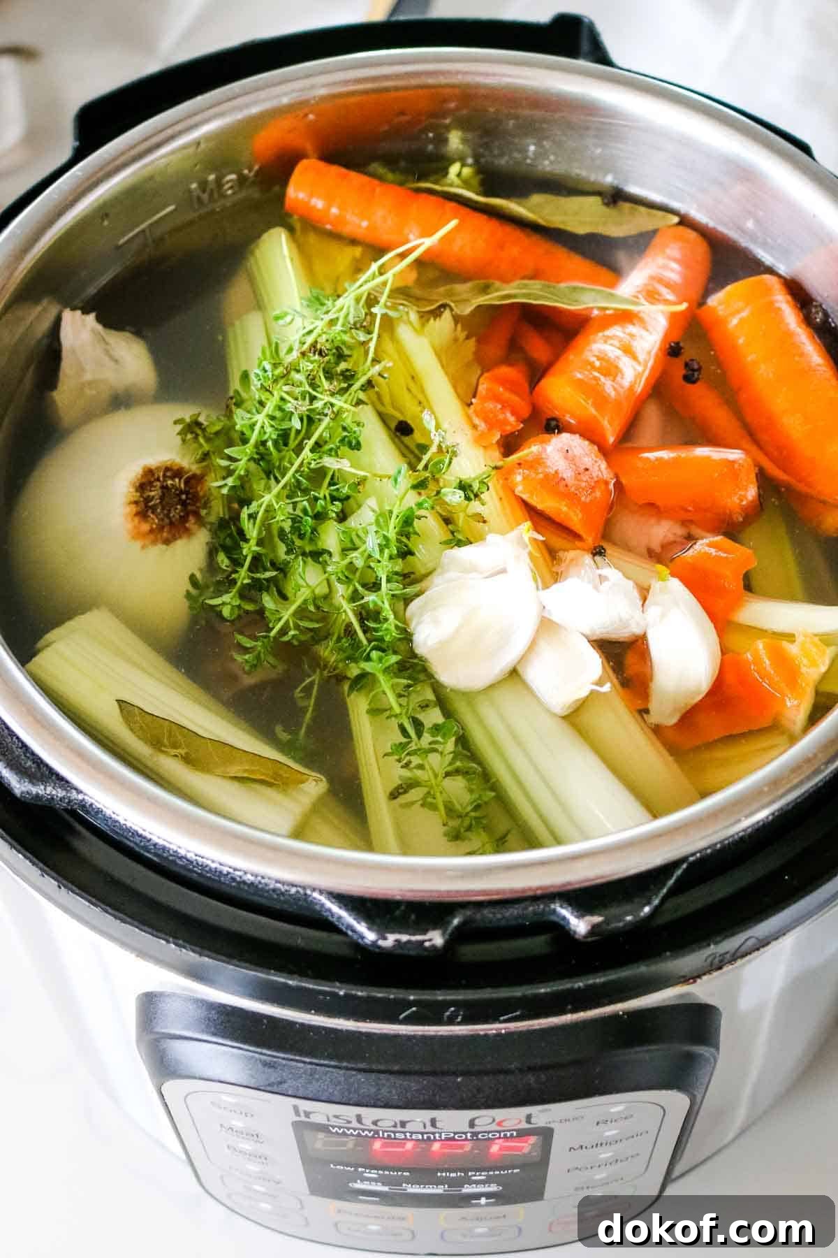 chicken and vegetables in water in instant pot.