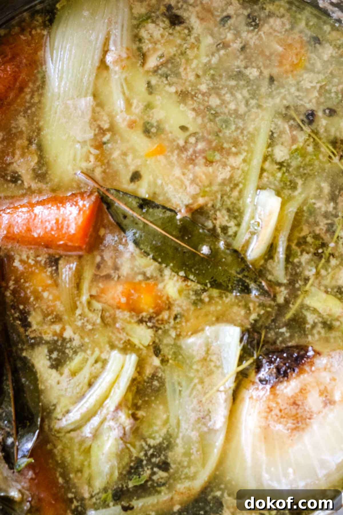 cooked broth with bay leaves and carrots.