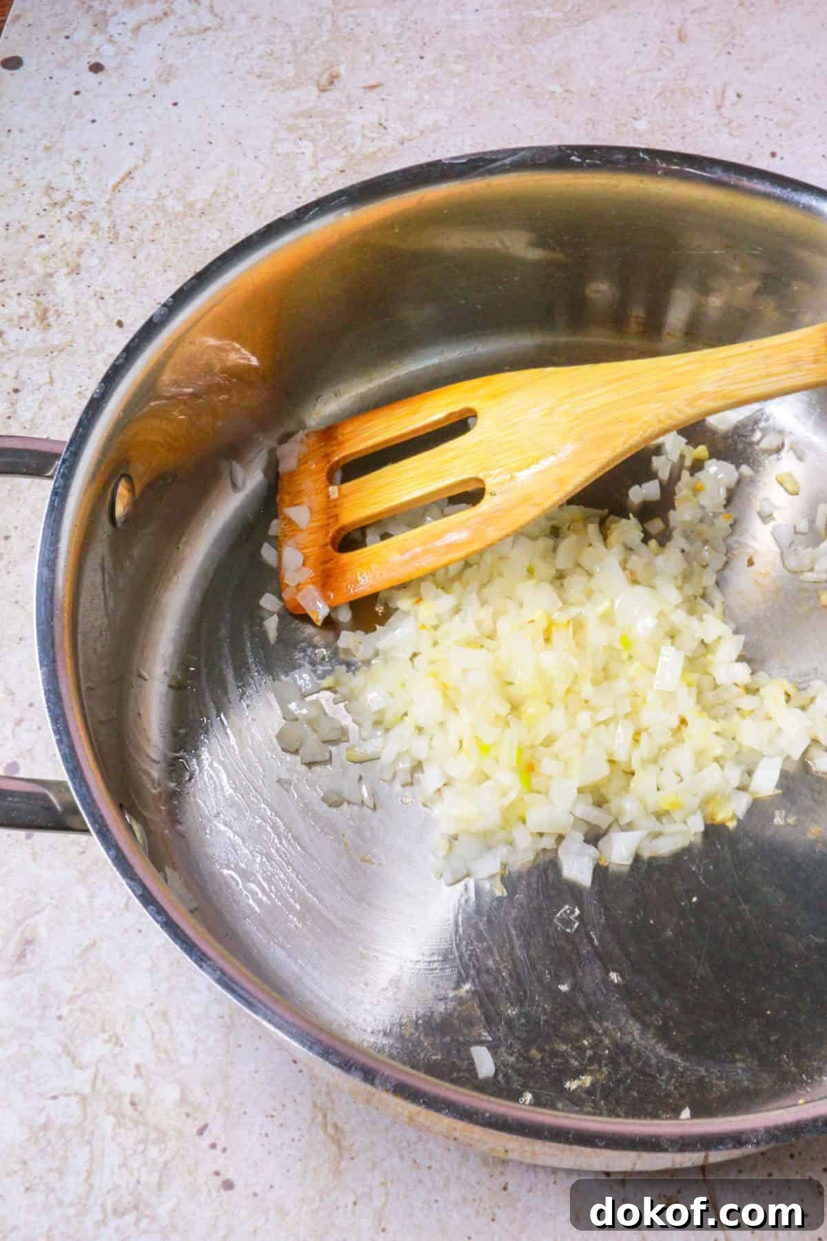 Sautéing diced garlic and onion in a pan