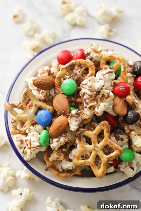 Savory Popcorn Trail Mix Recipe for Road Trips & Snacks 2 popcorn snack mix in a white bowl.