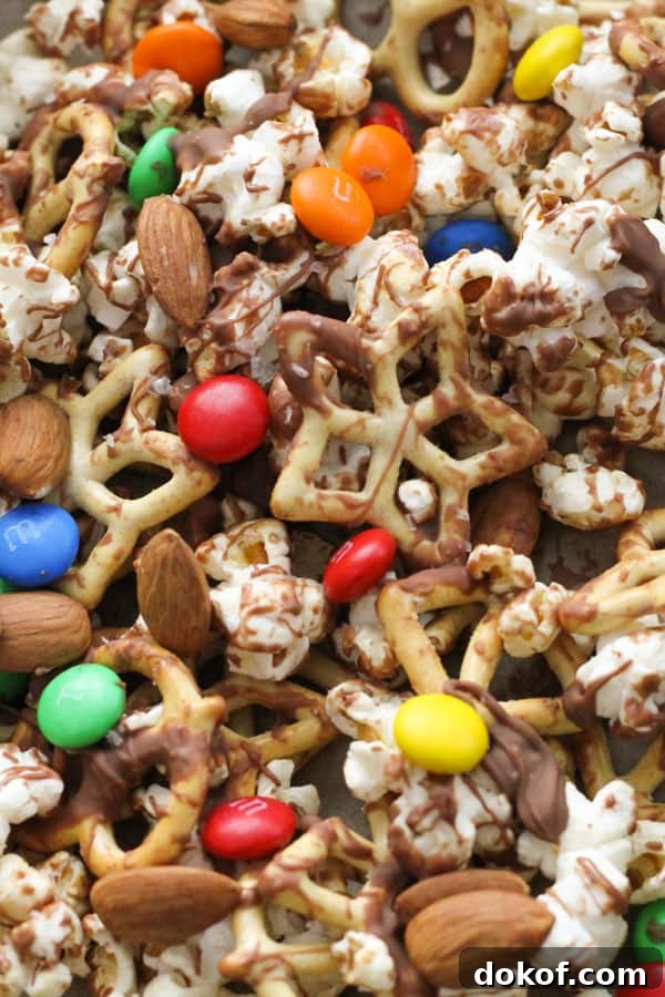 Savory Popcorn Trail Mix Recipe for Road Trips & Snacks 3 popcorn snack mix on a baking tray.