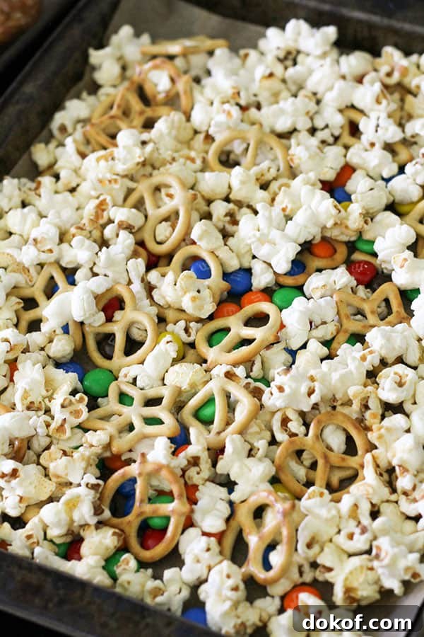 Savory Popcorn Trail Mix Recipe for Road Trips & Snacks 5 popcorn snack mix on a baking tray.