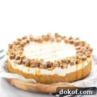 Gluten Free Chocolix No Bake Cheesecake recipe on a round wood board lined with wax paper.