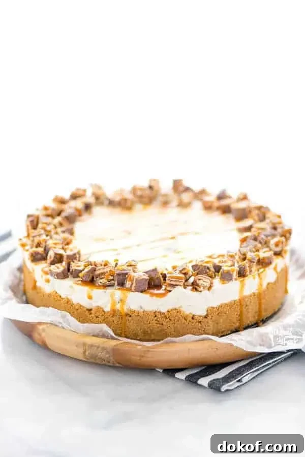 Gluten Free Chocolix No Bake Cheesecake recipe on a round wood board lined with wax paper