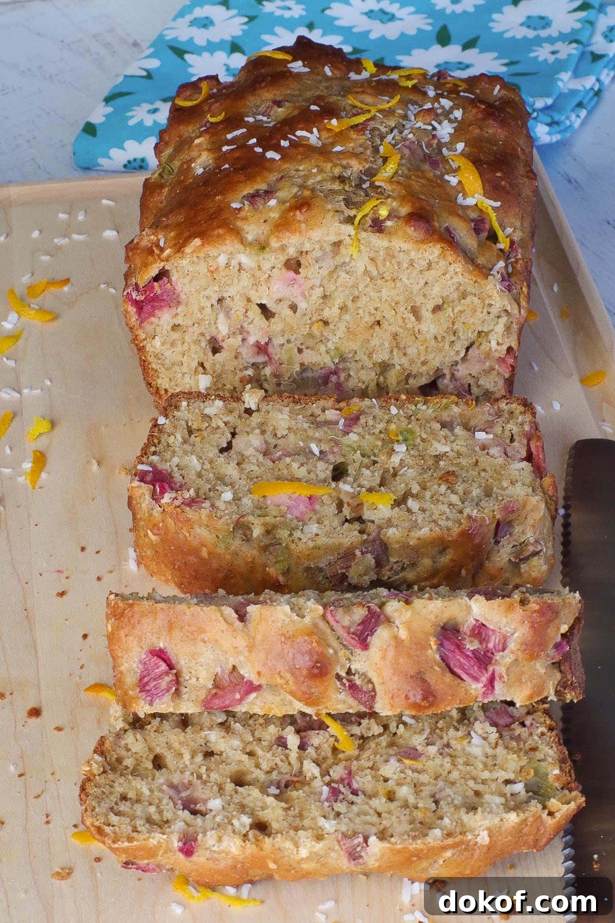 healthy rhubarb bread on a cutting board with 3 pieces sliced
