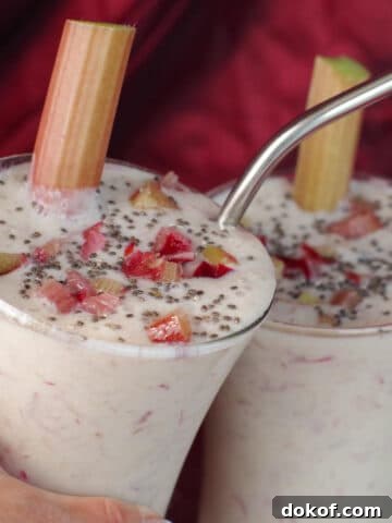 2 rhubarb smoothies clinking glasses