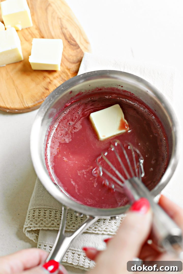 woman showing how to make raspberry curd, whisking butter into a saucepan
