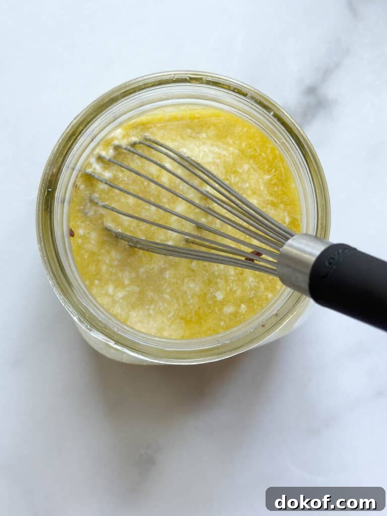 Whisking the dressing in a mason jar.