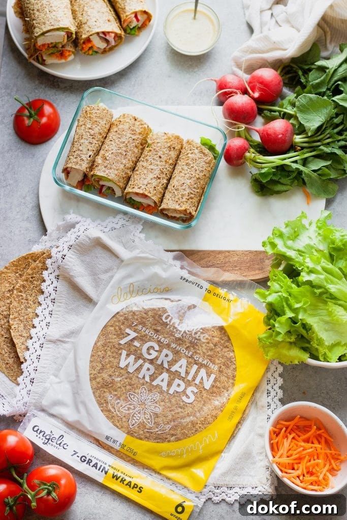 Chicken Caesar Wrap Recipe: Quick Protein-Packed Lunch 8 Healthy Chicken Caesar Wraps in a glass container with a tomato, lettuce, radishes, a bowl of Caesar dressing and a plate of wraps.