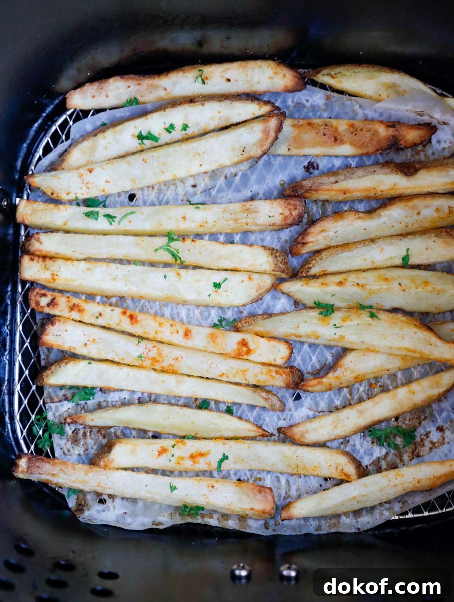 French fries inside an air fryer basket.