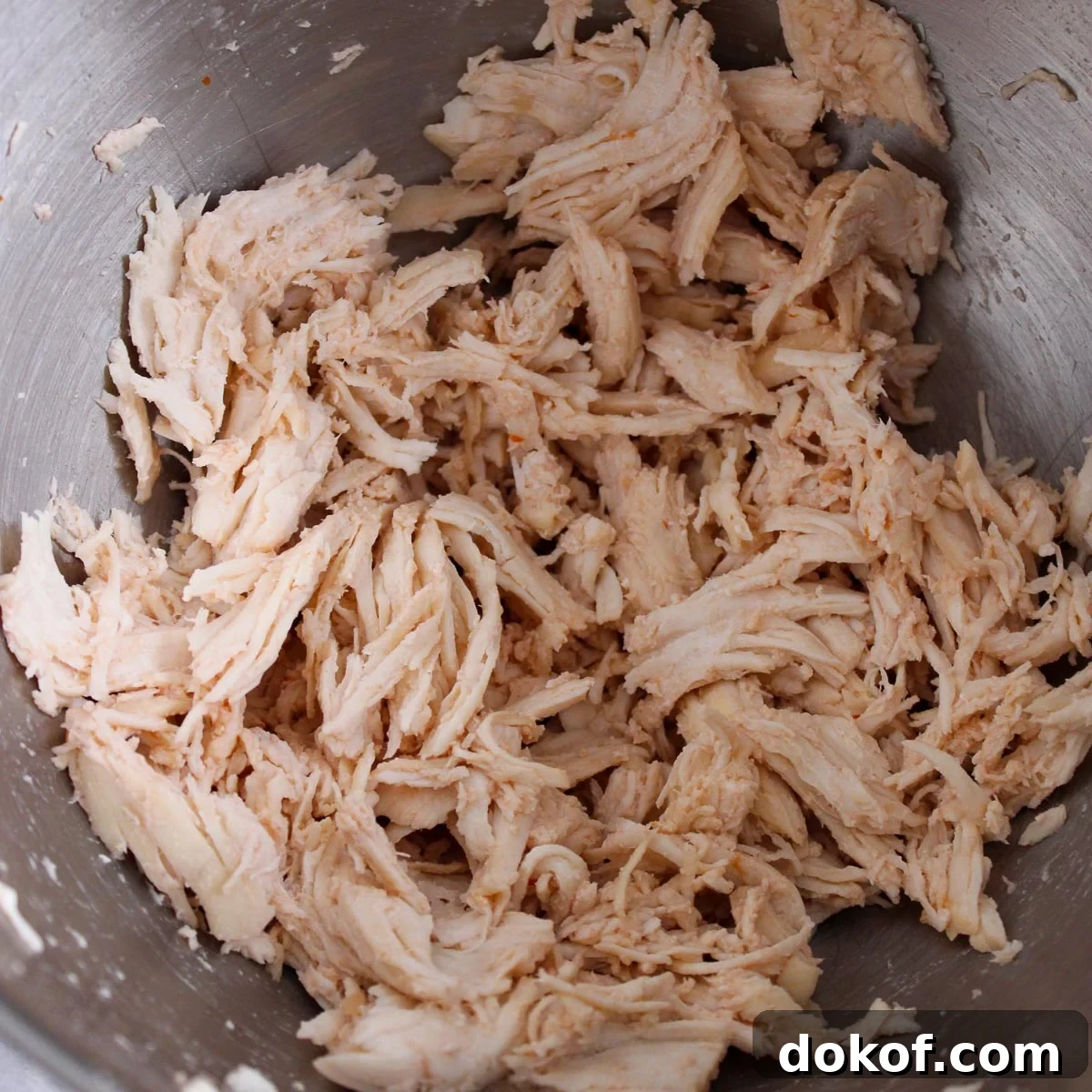 Shredded chicken once it is cooked in the soup. 