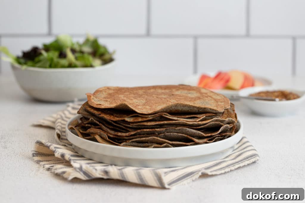 Cooked buckwheat crepes stacked on a plate.