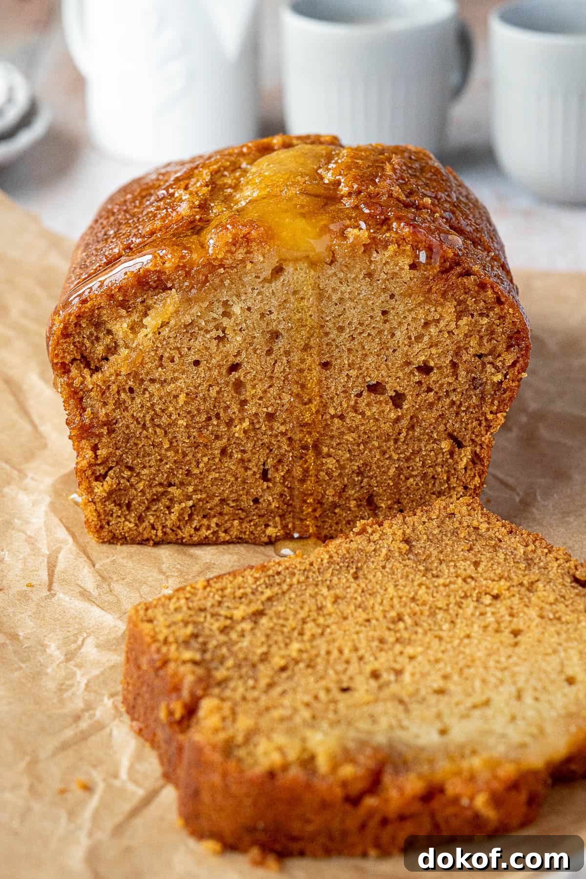 Moist Vegan Golden Syrup Cake Recipe with Sticky Glaze 2 Vegan golden syrup cake with one slice removed.