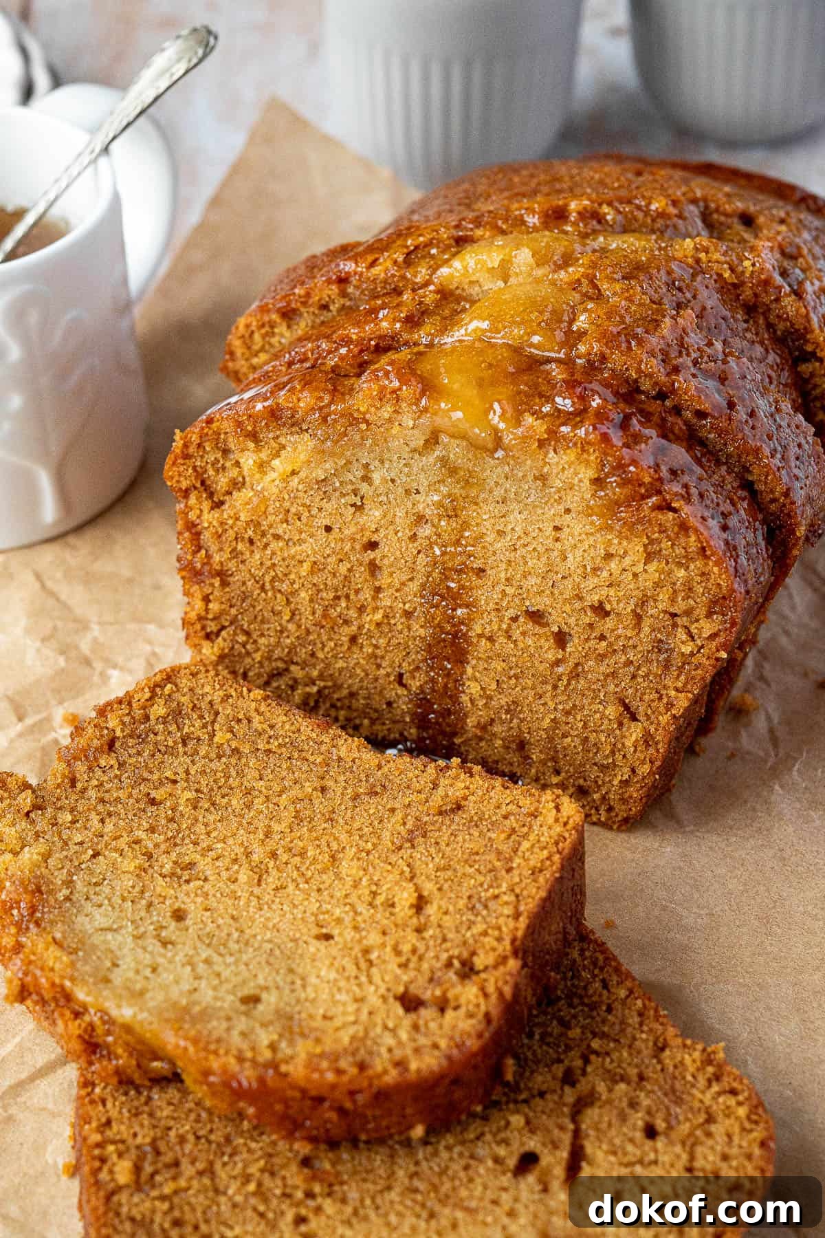 Moist Vegan Golden Syrup Cake Recipe with Sticky Glaze 4 Sliced golden syrup cake with a jug of golden syrup.