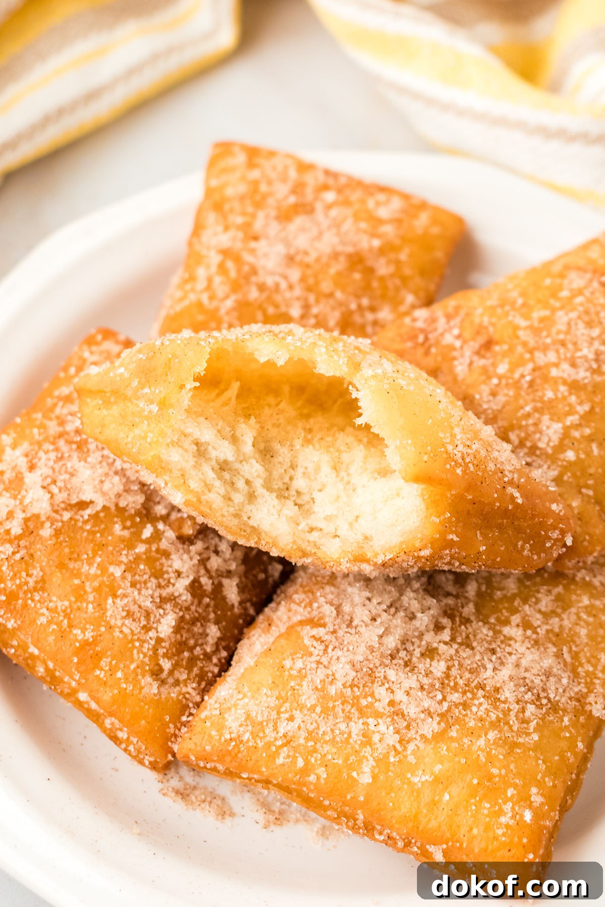 Sopapillas on a plate with a sugar-cinnamon topping.