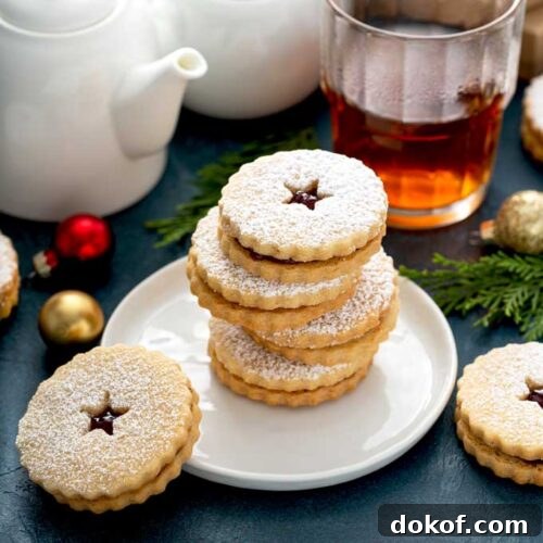Classic Linzer Cookies Recipe: How to Make Austrian Jam Sandwich Cookies 11 Small stack of cookies on a white plate