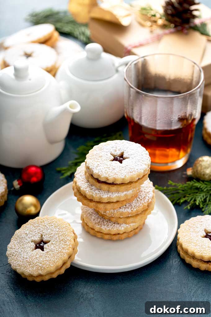 Classic Linzer Cookies Recipe: How to Make Austrian Jam Sandwich Cookies 9 Linzer cookies stack on a white plate