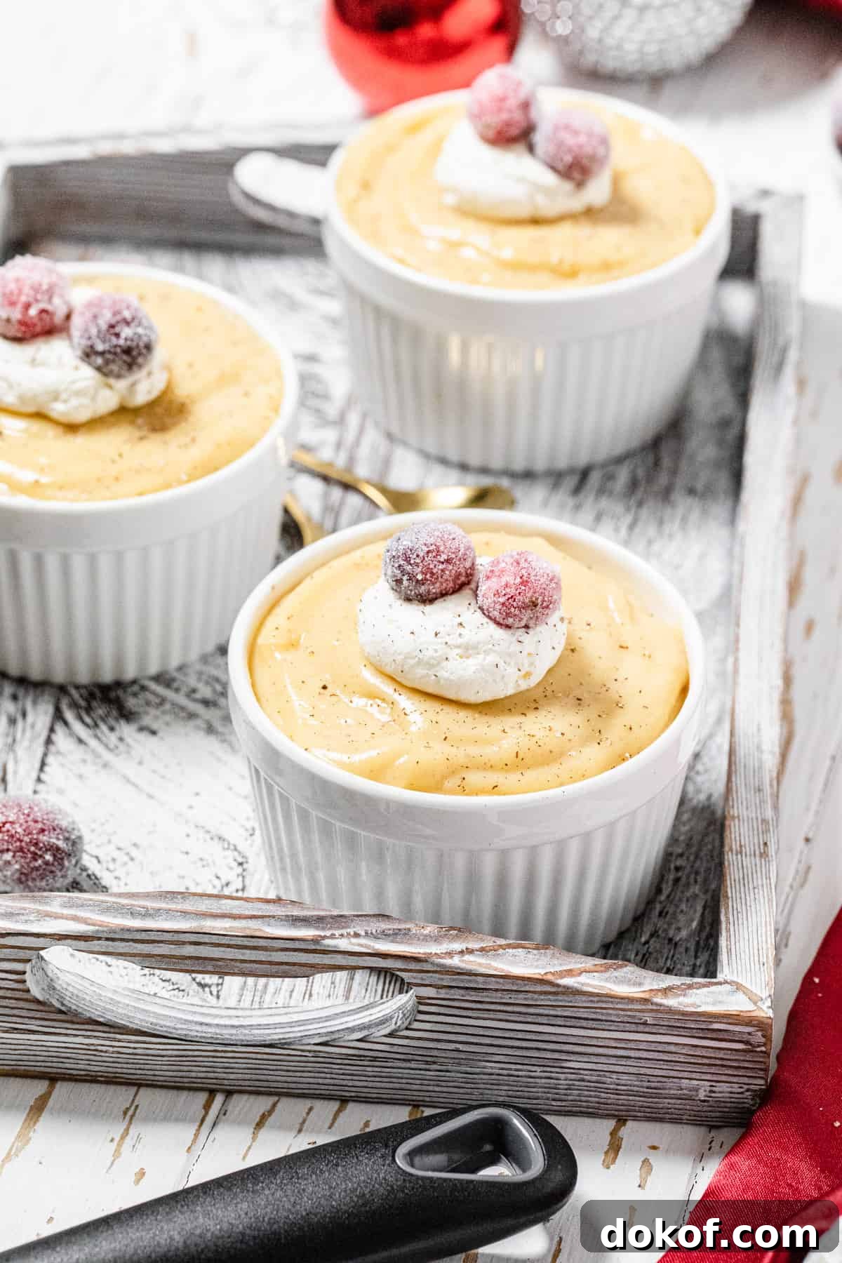 Creamy Homemade Eggnog Pudding Recipe for the Holidays 2 three ramekins filled with pudding in a white wooden tray