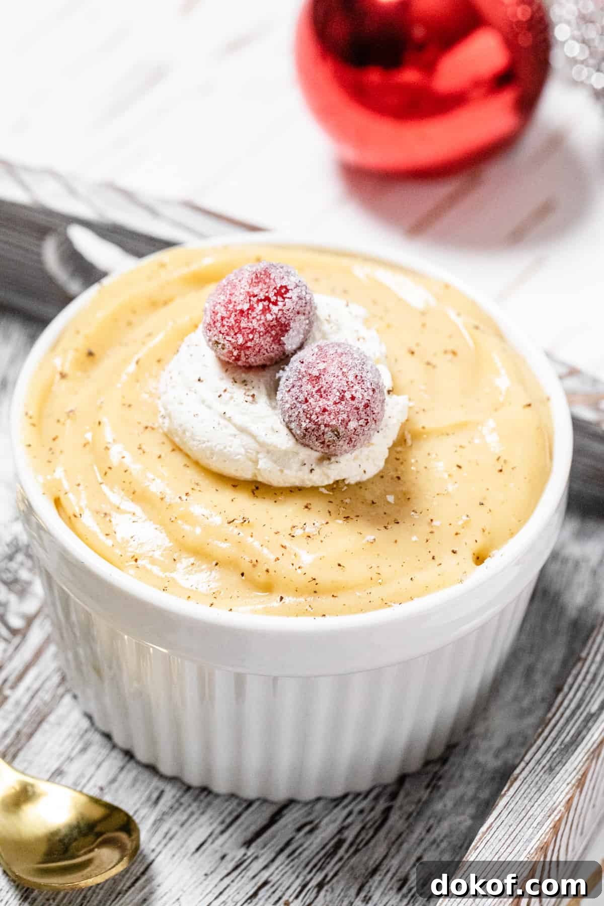 Creamy Homemade Eggnog Pudding Recipe for the Holidays 7 close up of pudding topped with sugared cranberries