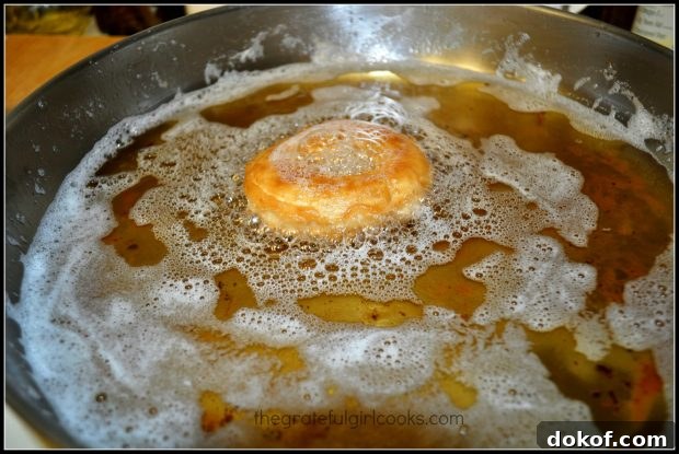 The pumpkin buttermilk doughnuts are fried in oil to cook.