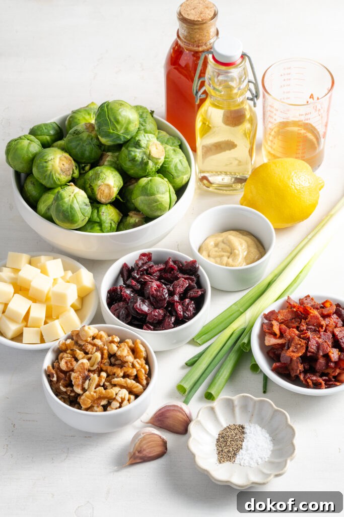 Citrus-Shaved Brussels Sprout Salad with Toasted Almonds 5 ingredients needed to make shaved brussels sprouts salad recipe measured out on a white table.