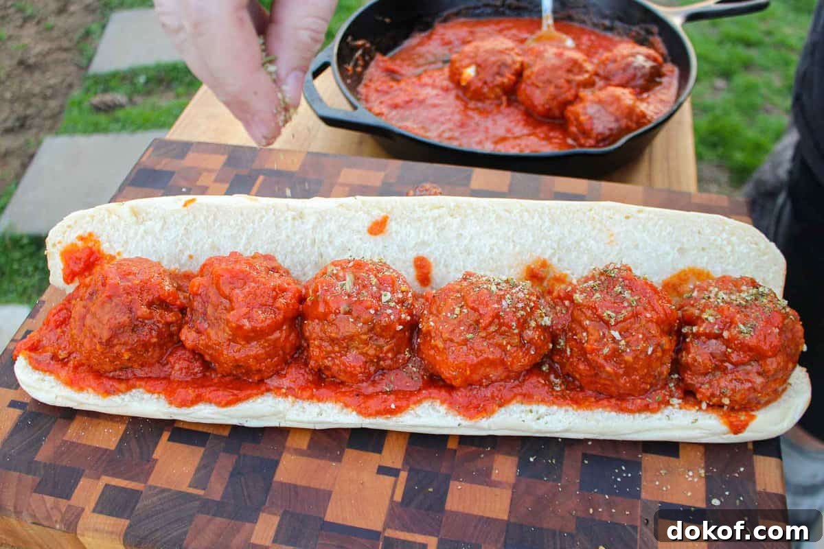 Assembling the Smoked Meatball Sub.