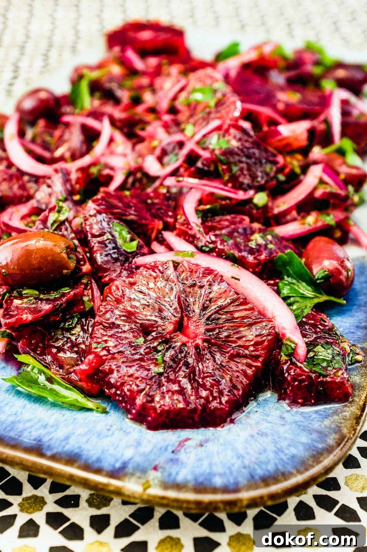 Moroccan Blood Orange Salad | cookeatworld.com A platter of blood orange salad with black olives, onion and herbs