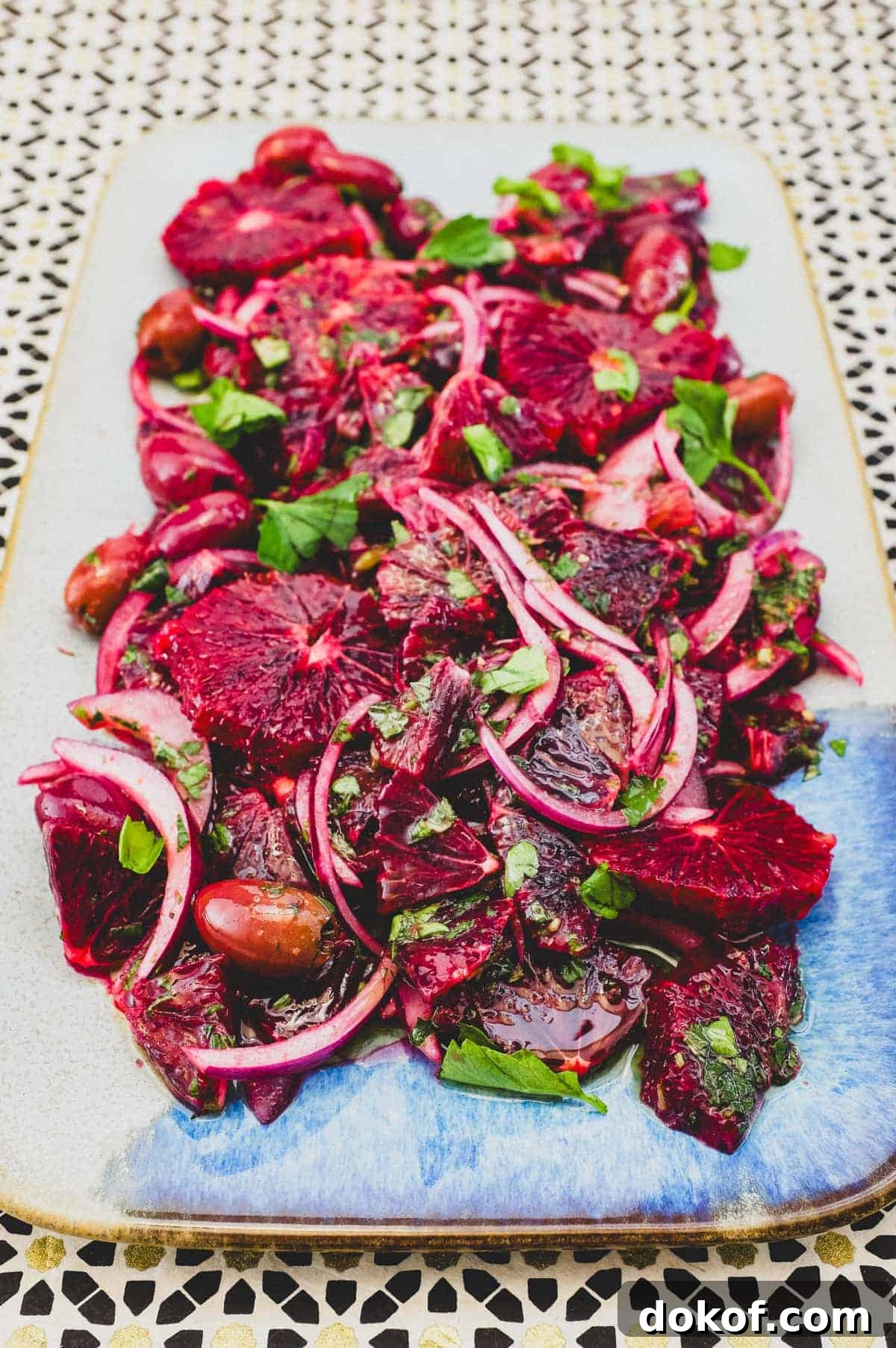 Moroccan Blood Orange Salad | cookeatworld.com A platter of blood orange salad with black olives, onion and herbs