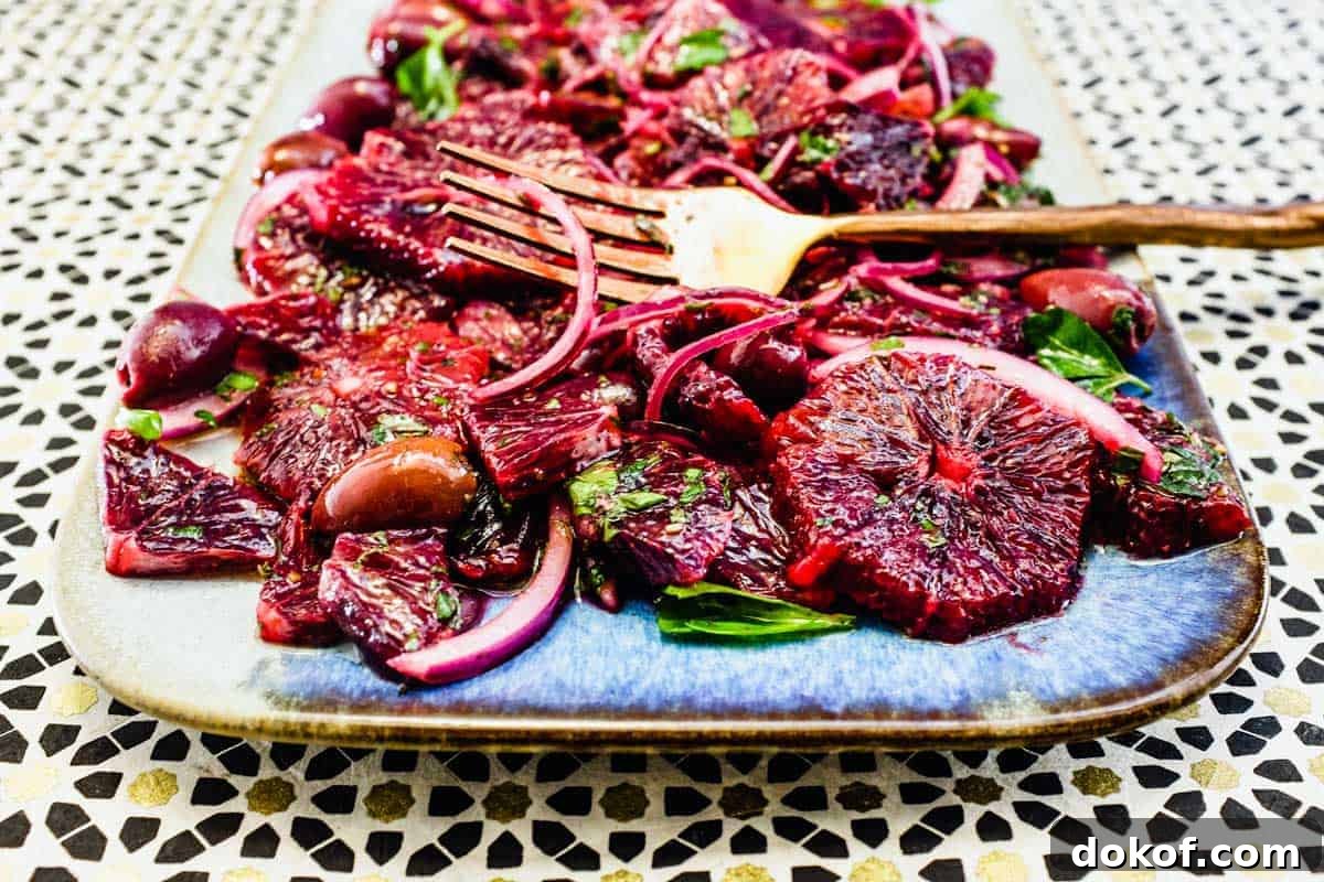 Moroccan Blood Orange Salad with Cumin & Mint Dressing 2 A platter of blood orange salad with black olives, onion and herbs