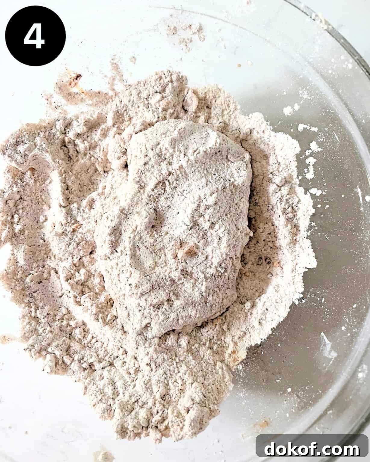 chicken breast in a flour mixture in a bowl.